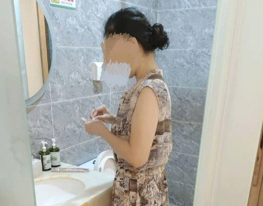 Godmother in a dress plays with her godson while wearing the clothes. madou